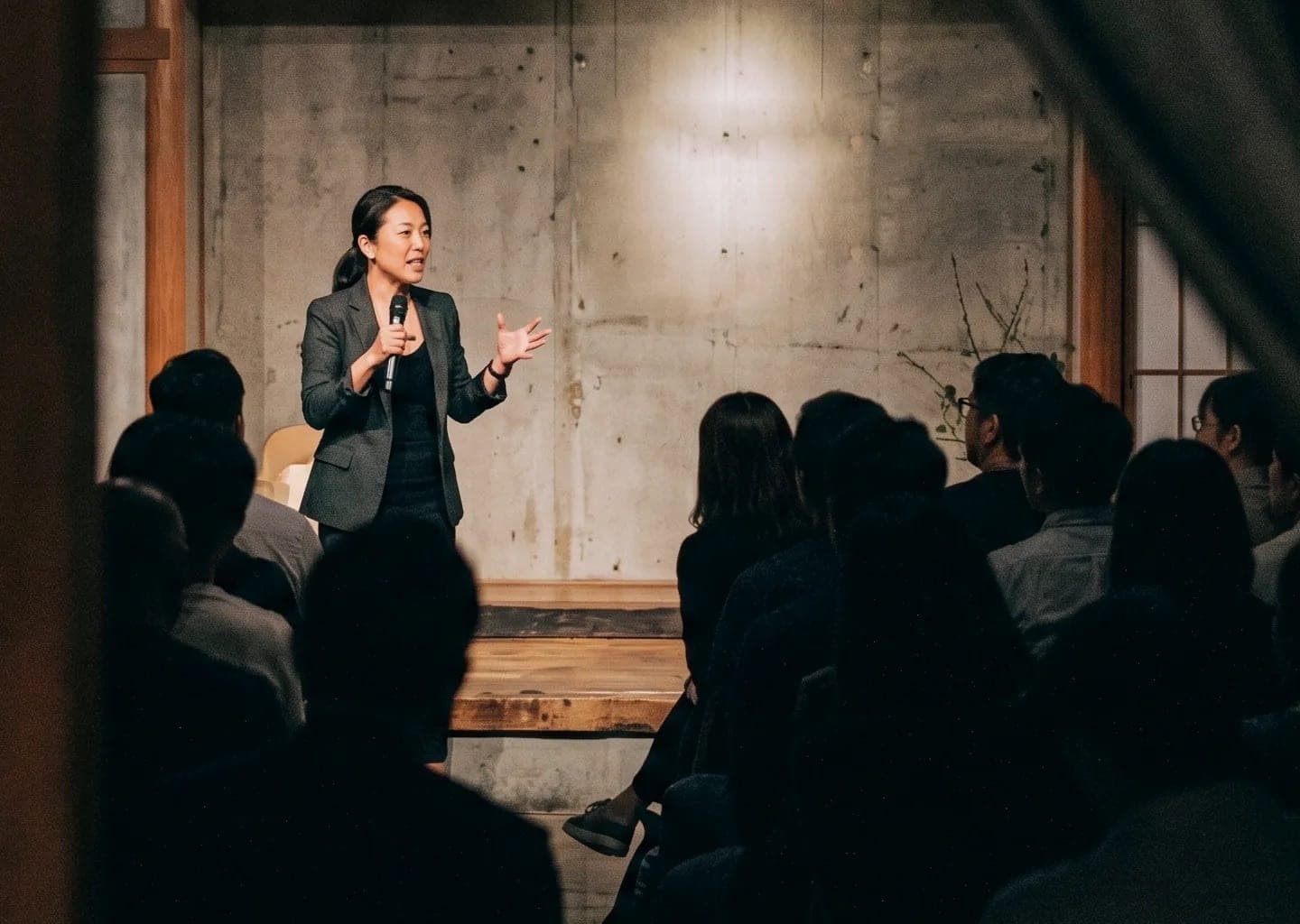 A speaker addressing an intimate, seated audience